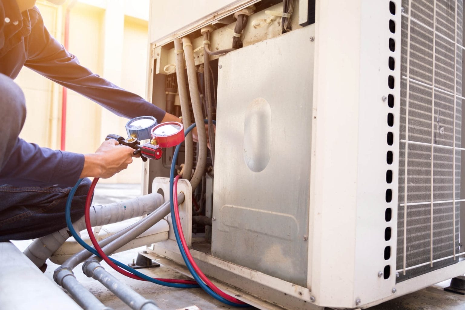 Technician Performing HVAC Maintenance on Air Conditioning Unit
