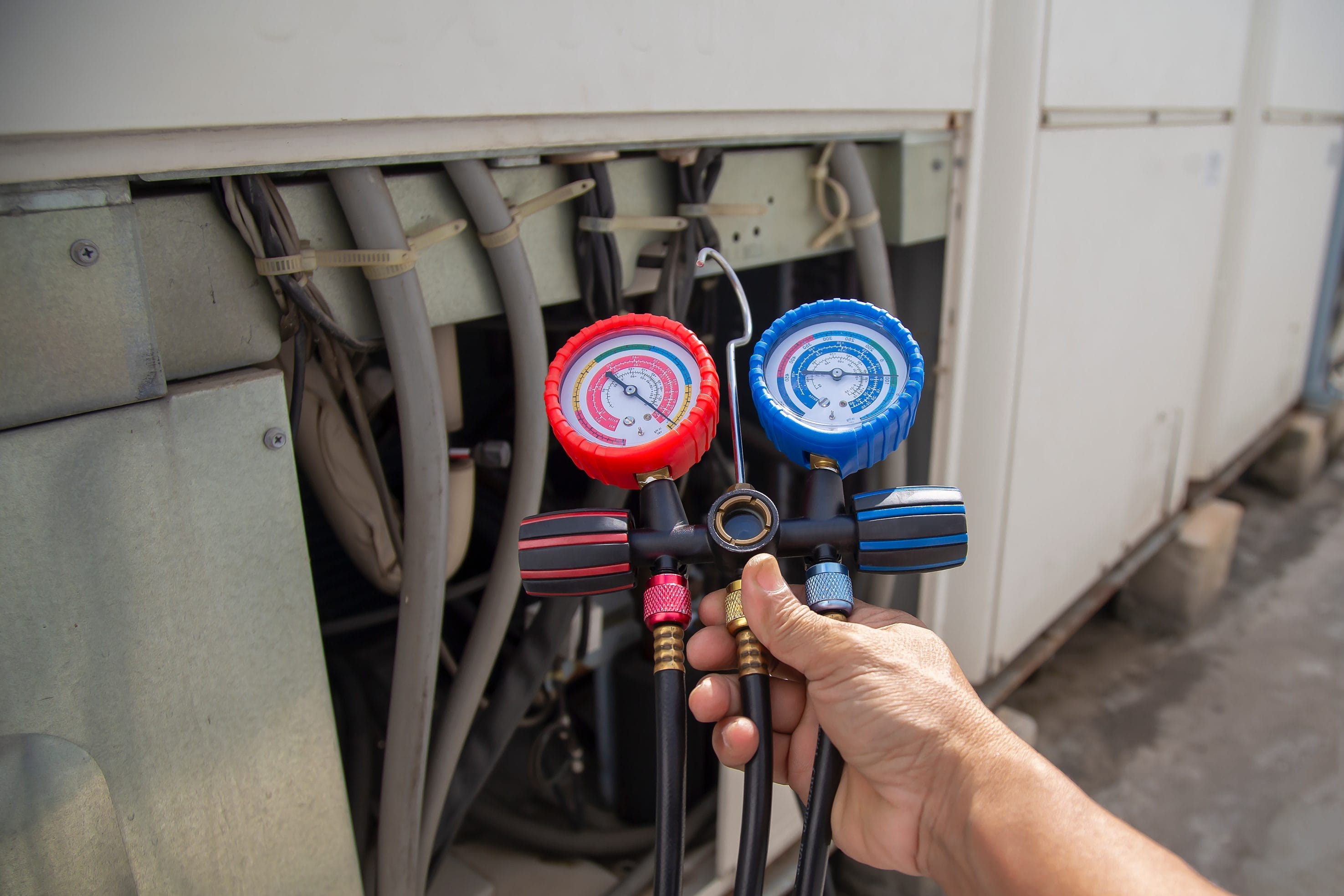 Technician performing AC service and repair
