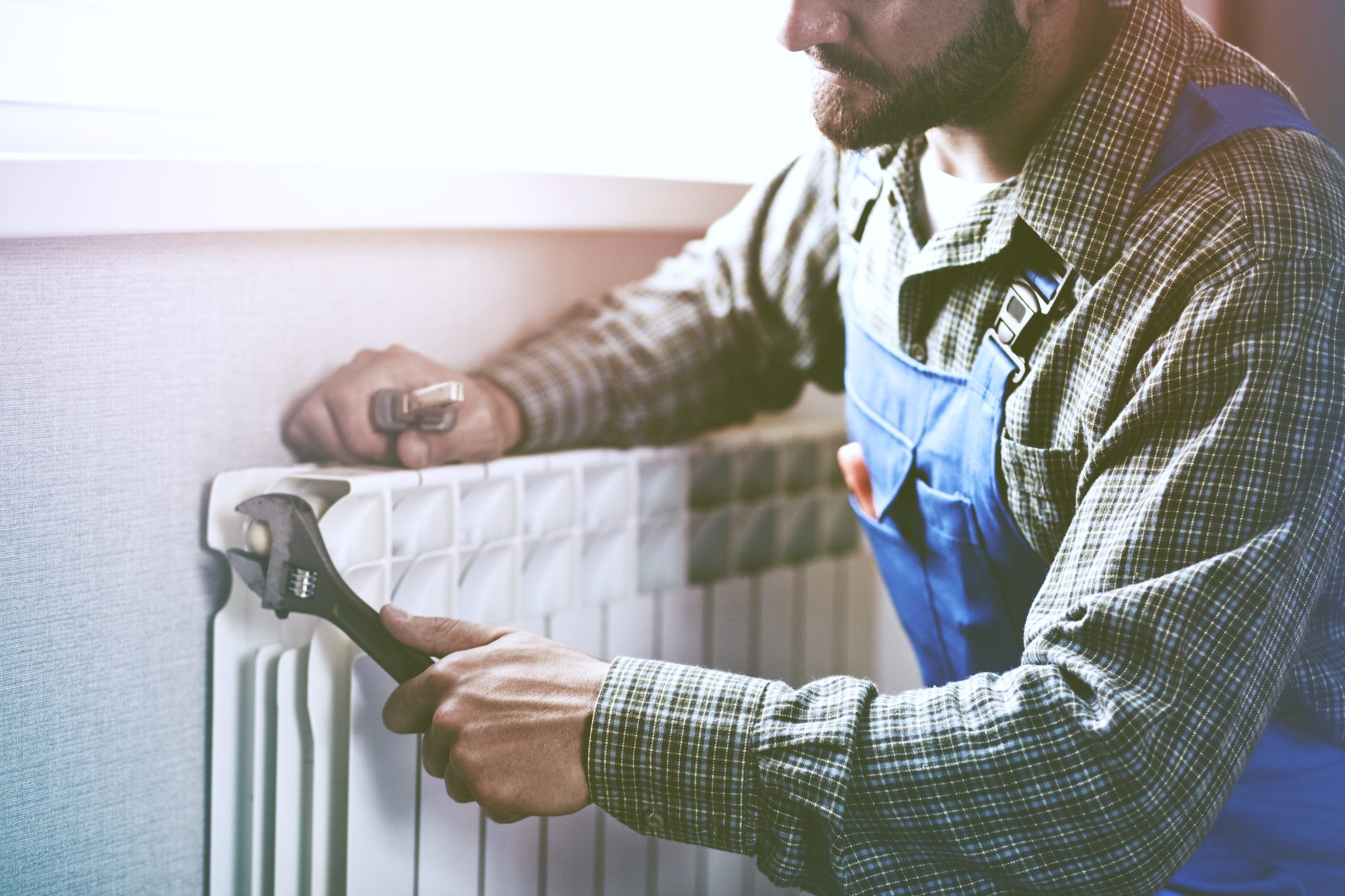 Technician Repairing a Heater Radiator
