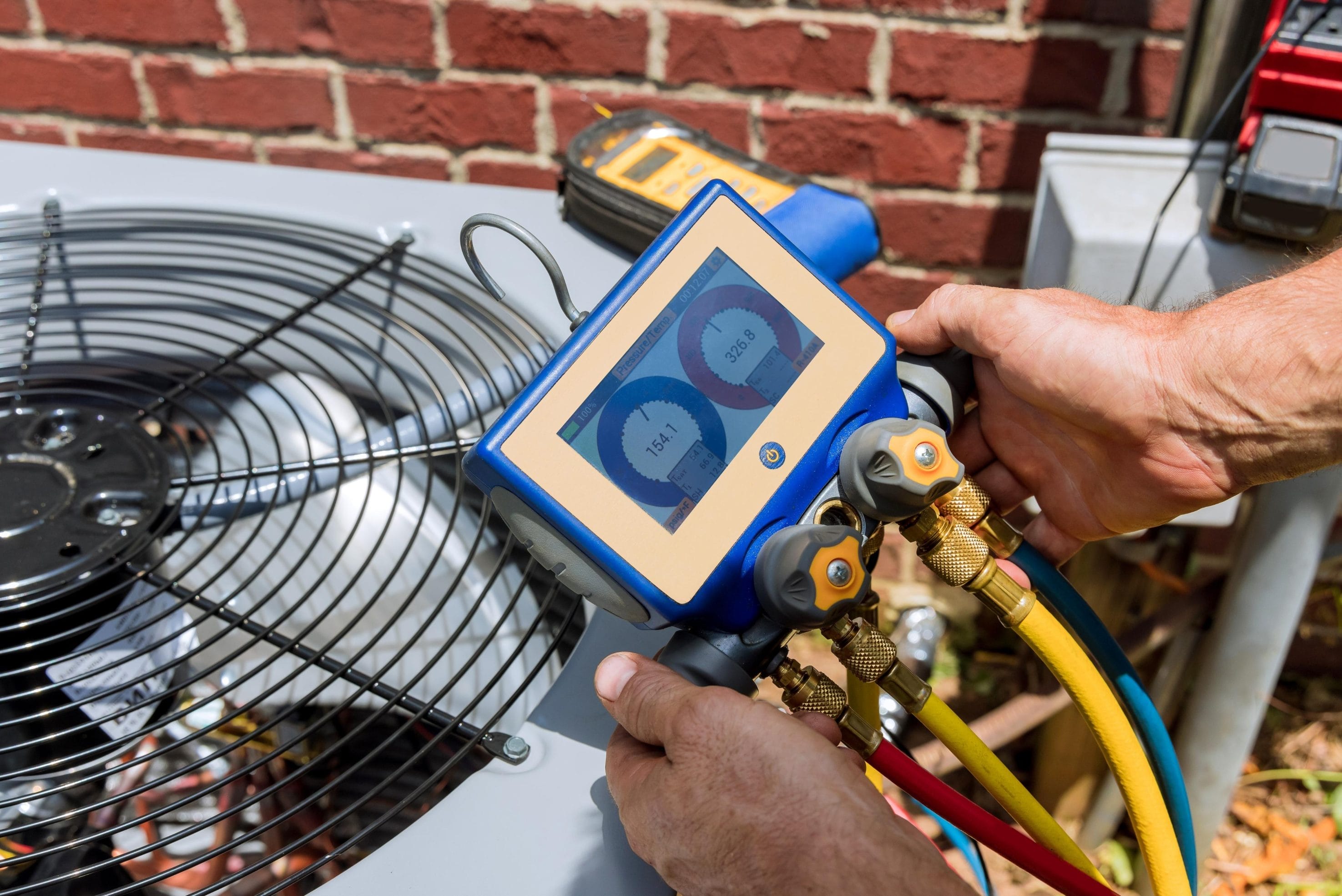 Technician Performing AC Installation with Pressure Gauge
