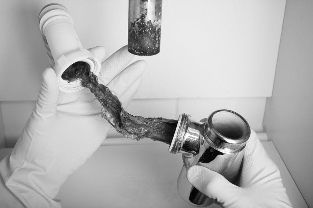 Plumber Performing Drain Cleaning Task