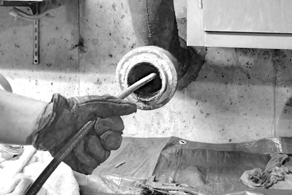 Plumber Performing Drain Cleaning Service